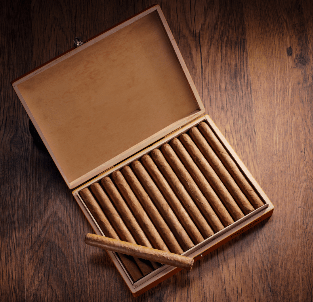 Open cigar box with wooden background.